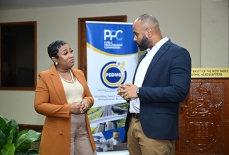Executive Director at the Public Procurement Commission (PPC), Nadia Morris (left), having a conversation with Chief Public Procurement Policy Officer, Office of the Public Procurement Policy (OPPP), Andrei Bennett,  during the Public Procurement Seminar, held at the UWI Regional Headquarters, Mona, St. Andrew, on Thursday (January 23).