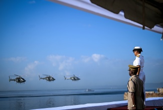 Chief of Defence Staff, Vice Admiral Antonette Wemyss-Gorman (right), observes the fly past of aerial assets at the Kingston Waterfront during the opening ceremony for the third staging of Exercise Event Horizon 2025, held on the recreational lawns of the Bank of Jamaica, downtown Kingston, on January 13.