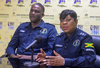 Head of the Constabulary Communications Network (CCN), Senior Superintendent of Police (SSP), Stephanie Lindsay (right), addresses a recent Think Tank held at the Jamaica Information Service (JIS) head office in Kingston. Listening is Superintendent Lloyd Darby of the Public Safety and Traffic Enforcement Branch (PSTEB).

