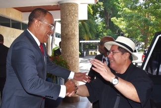Minister of Health and Wellness, Dr. the Hon. Christopher Tufton (left), greets Secretary of Health for the Republic of the Philippines, Dr. Teodoro J. Herbosa, on his arrival at The Jamaica Pegasus hotel in New Kingston on Monday (January 20), for an official visit to Jamaica.  Dr. Herbosa will deliver the keynote address at the Ministry’s inaugural Careers in Health Expo, scheduled for January 22 to 23 at the University of the West Indies, Mona.