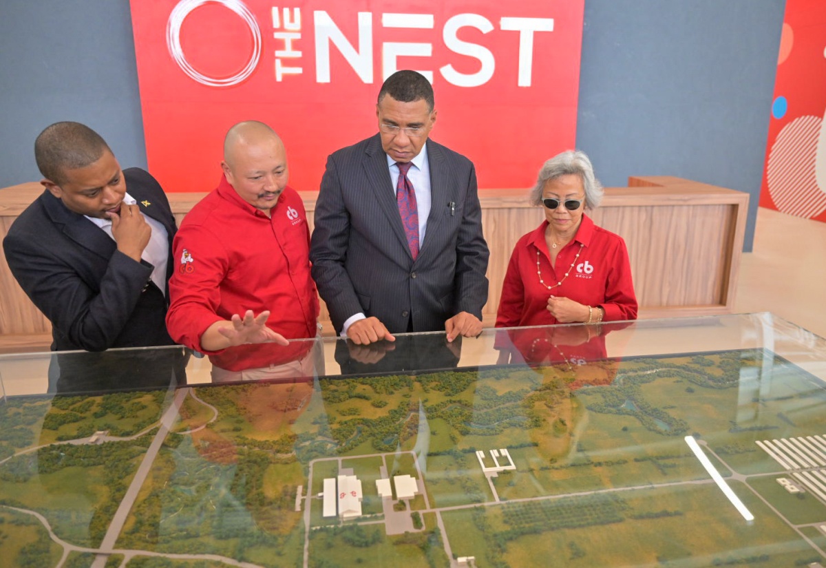 Prime Minister, Dr. the Most Hon. Andrew Holness (second right), and Minister of Agriculture, Fisheries and Mining, Hon. Floyd Green (left), view a replica of Caribbean Broilers (CB) Group’s multimillion-dollar Air Chill Poultry Processing Plant, during the official opening of the facility in Hill Run, St. Catherine, on January 15. Highlighting the features is Chief Executive Officer of CB Group, Matthew Lyn (second left), while Chairman of the Group, Lori-Ann Lyn, looks on. 