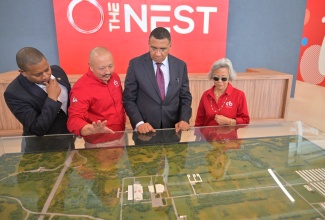 Prime Minister, Dr. the Most Hon. Andrew Holness (second right), and Minister of Agriculture, Fisheries and Mining, Hon. Floyd Green (left), view a replica of Caribbean Broilers (CB) Group’s multimillion-dollar Air Chill Poultry Processing Plant, during the official opening of the facility in Hill Run, St. Catherine, on January 15. Highlighting the features is Chief Executive Officer of CB Group, Matthew Lyn (second left), while Chairman of the Group, Lori-Ann Lyn, looks on.