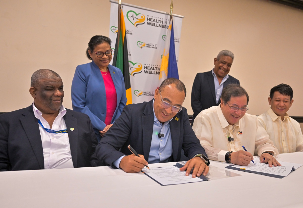 Minister of Health and Wellness, Dr. the Hon. Christopher Tufton (second left-seated), and Secretary of Public Health in the Philippines, Dr. Teodoro J. Herbosa (second right-seated), sign a Memorandum of Understanding (MOU) for health cooperation, at The Jamaica Pegasus hotel in New Kingston on Thursday (January 23). Observing (seated from left) are Permanent Secretary in the Ministry, Errol Greene; and Health Programme Officer for the Philippines, Edwin Amoso. Standing (from left) are Chief Medical Officer (CMO), Dr. Jacquiline Bisasor-McKenzie; and Honorary Consul for the Philippines, Keith Russell.