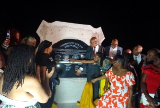Residents of the St. Catherine community of Old Harbour Bay, celebrate the unveiling of a monument in honour of community leaders in the area, during a recent Homecoming Recognition Ceremony held at the community centre.