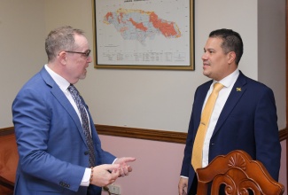 Minister without Portfolio in the Ministry of Economic Growth and Job Creation, Hon. Matthew Samuda (right), speaks with Canadian High Commissioner to Jamaica, His Excellency Mark Berman, during a courtesy call at the Ministry’s New Kingston offices on Wednesday (January 21).