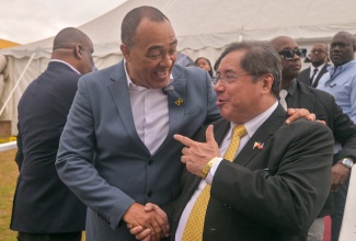 Minister of Health and Wellness, Dr. the Hon. Christopher Tufton (left), shares a friendly handshake with Secretary of Public Health in the Philippines, Dr. Teodoro J. Herbosa, during the opening of the two-day Career Expo and Employment Fair at the University of the West Indies, Mona Campus, in St. Andrew on Wednesday  (January 22).

