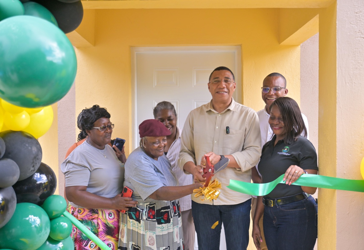 Prime Minister, Dr. the Most Hon. Andrew Holness (third right), cuts the ribbon to officially hand over a three-bedroom house under the New Social Housing Programme (NSHP) to Neita Grey (second left) in Bath Mountain , Westmoreland, on Friday (January 24). Joining them (from left) are Mrs. Grey’s daughter, Sonia Grey-Royal; Chairperson of the NSHP Oversight Committee, Judith Robb Walters; Member of Parliament for Western Westmoreland, Morland Wilson; and Permanent Secretary in the Ministry of Economic Growth and Job Creation, Arlene Williams. Mrs. Grey received one of four homes handed over in Westmoreland by the Prime Minister on the day.

