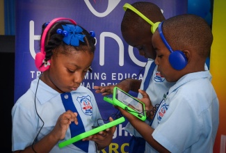 Students of Jamaica China Goodwill Infant School I engage in numeracy and literacy activities on OneTab tablets donated by the Project for the Advancement of Childhood Education (PACE) Canada, in collaboration with local partners, during a handover ceremony held at the Kingston institution on Tuesday (January 7).

