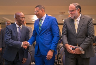 Prime Minister, Dr. the Most Hon. Andrew Holness (centre), is greeted by Deputy Governor General, Hon. Steadman Fuller (left), at  the National Leadership Prayer Breakfast (NLPB), held at The Jamaica Pegasus hotel in New Kingston, on January 16.  At right is Leader of the Opposition, Mark Golding.

