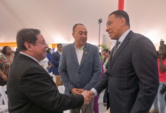 Prime Minister, Dr. the Most Hon. Andrew Holness (right), greets Secretary of Health, Republic of the Philippines, Dr. Teodoro J. Herbosa (left), at the opening ceremony for the health and wellness career exposition and employment fair, at the Old Library, University of the West Indies, Mona campus, in St. Andrew, on January 22. At centre is Minister of Health and Wellness, Dr. the Hon. Christopher Tufton.

