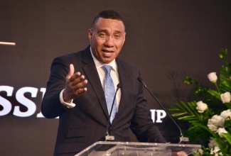 Prime Minister, Dr. the Most Hon. Dr. Andrew Holness, leads the tributes at the funeral of the late businessman Robert “Ducksie” Russell at the Montego Bay Convention Centre, St. James, on January 8.

