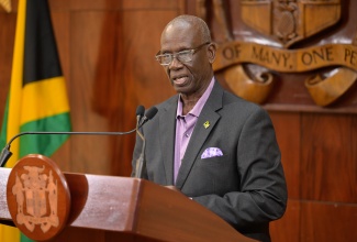 Minister of Local Government and Community Development, Hon. Desmond McKenzie, addresses a recent post-Cabinet press briefing at Jamaica House in St. Andrew.