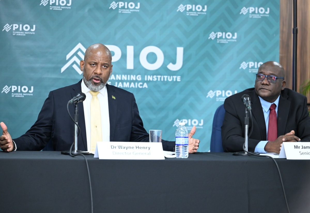 Director General of the Planning Institute of Jamaica (PIOJ), Dr. Wayne Henry (left), points out that the island is not in a recession, during a press briefing at the Don Mills Training Room, PIOJ, 16 Oxford Road, on Wednesday (February 19). He is joined by Senior Director at the PIOJ, James Stewart (right).

