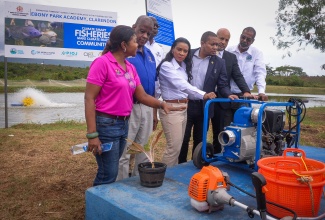  Minister of Agriculture, Fisheries and Mining, Hon. Floyd Green (third right) hands over equipment to the Clarendon based Ebony Park Heart Academy on January 31, during a ceremony held at the institution. Others pictured from left are Project Manager with the National Fisheries Authority (NFA), Selena Ledgister; Minister of State in the Ministry, Hon. Franklyn Witter; Chief Technical Director in the Ministry, Orville Palmer; Managing Director of the HEART/NSTA Trust, Dr. Taneisha Ingleton; Senior Environmental Specialist with the World Bank, Kirk C.N. Brown; and Chief Executive Officer of the NFA, Dr. Gavin Bellamy.