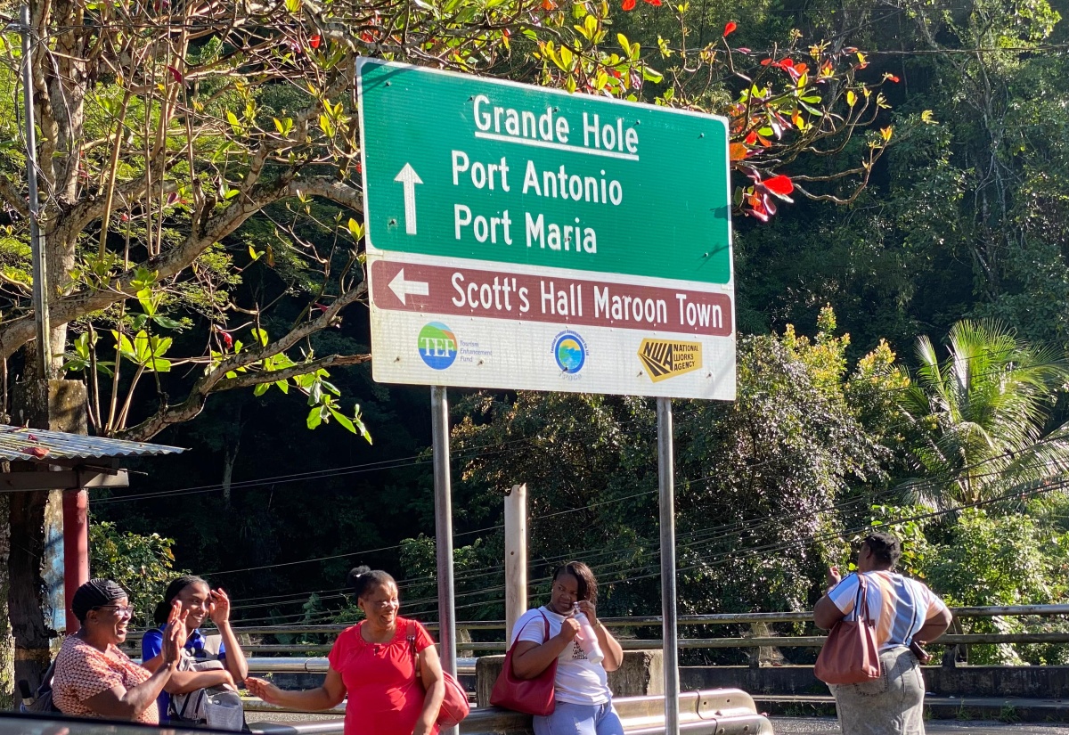 Commuters awaiting the arrival of the 52B at Grande Hole in St. Mary recently.