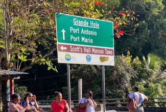 Commuters awaiting the arrival of the 52B at Grande Hole in St. Mary recently.