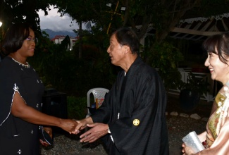 Member of Parliament for St. Andrew East Rural, the Most Hon. Juliet Holness (left), exchanges greetings with Japanese Ambassador to Jamaica, His Excellency Yasuhiro Atsumi (centre) during a reception to celebrate the birthday of His Majesty the Emperor of Japan, held on Thursday (February 20) at The Jamaica Pegasus hotel in New Kingston. Looking on is wife of the Ambassador, Tomoko Atsumi.