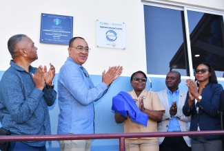 Minister of Health and Wellness, Dr. the Hon. Christopher Tufton (second left), applauds at the reopening of the Thompson Town Health Centre in Clarendon on February 20, after it was renovated at a cost of $25 million. Others (from left) are Vice Chairman of the Southern Regional Health Authority (SRHA), Michael Stern; Public Health Nurse, Anita Dwyer; Councillor for the Thompson Town Division, Collin Henry, and Senior Director at the National Health Fund (NHF), Grace-Ann Johnson.
