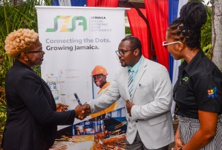 Senior Director, Regulations, Policy, Monitoring and Enforcement at the Jamaica Special Economic Zone Authority (JSEZA), Ainsley Brown (centre), greets Vice President, Exports, Jamaica Promotions Corporation (JAMPRO), Sonja Linton (left), while Director, Stakeholder Relationship Management, JSEZA, Yenniek Hinds, observes. They were in attendance at the Business Acceleration Centre (BAC) Accelerator Series, at the Terra Nova All-Suite Hotel in Kingston, on Thursday (February 6).

