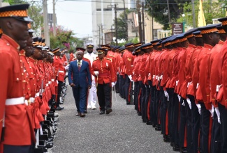 Custos of Kingston, Hon. Steadman Fuller (left), who deputised for Governor-General, His Excellency the Most Hon. Sir Patrick Allen, inspects the Guard of Honour, at the ceremonial opening of Parliament at Gordon House on Thursday, February 13. Custos Fuller delivered the Throne Speech.

