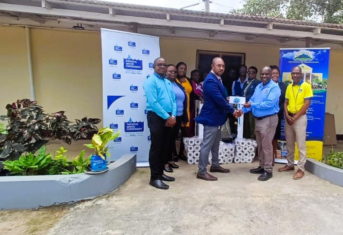 Acting Regional Manager for National Water Commission (NWC) – St. James and Trelawny, Horace Binns (second left), presents a cheque to Mayor of Falmouth, Councillor Colin Gager (third right) as part of an overall donation to the Trelawny Infirmary, during a handover ceremony held at the facility on January 30. Among the donations were a six-burner stove and toiletries. Sharing the moment is Chief Executive Officer of the Trelawny Municipal Corporation, Tamoy Sinclair (second right), as well as staff members from the NWC and the infirmary.