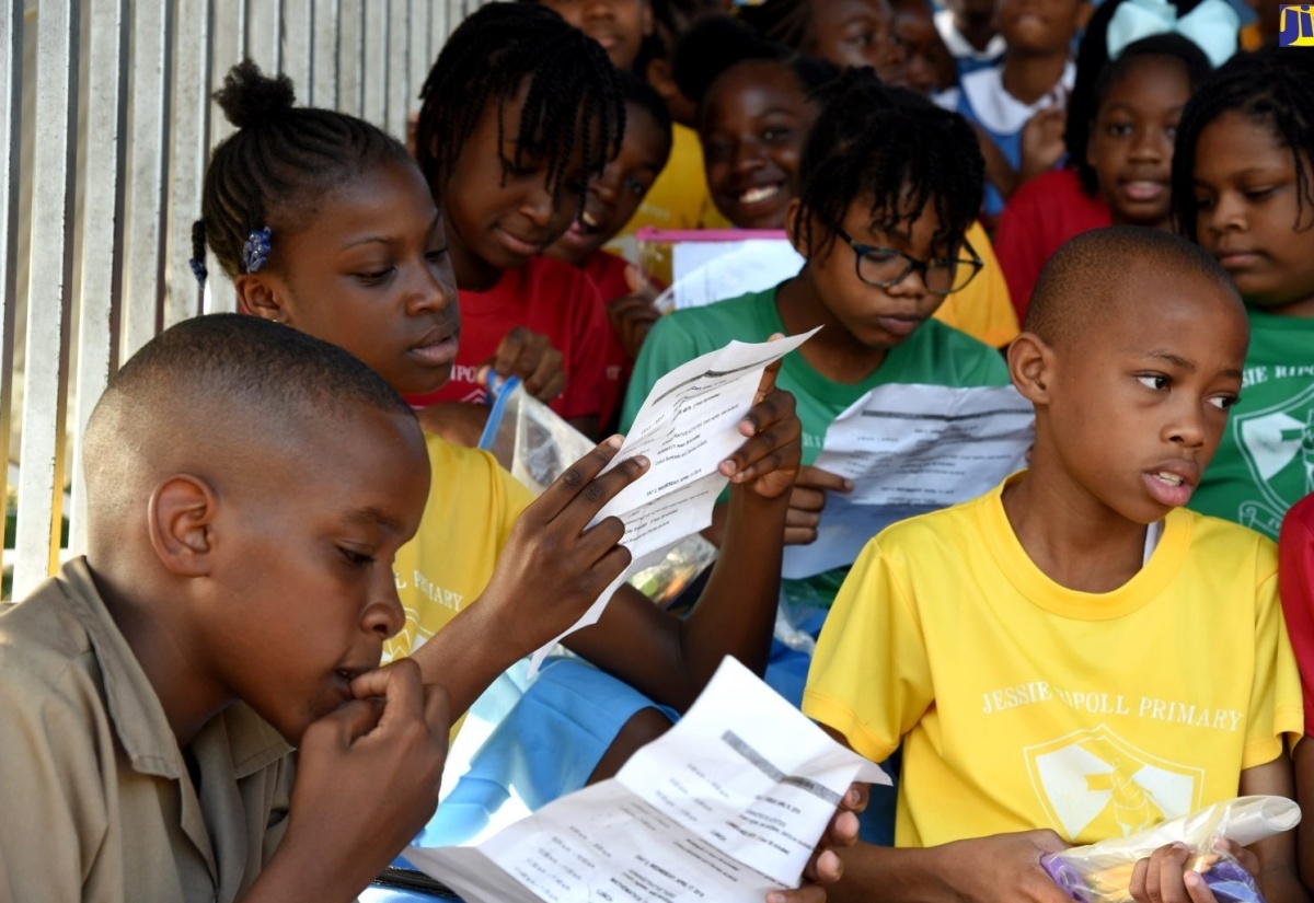 Students of Jessie Ripoll Primary School in Kingston review the schedule for the Primary Exit Profile (PEP) examinations.

