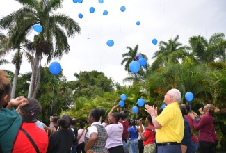 Minister of Justice, Hon. Delroy Chuck, participates in a balloon release with students of Oberlin High School at Hope Gardens in St. Andrew on Thursday (February 6). The exercise was part of a resocialisation intervention activity hosted by the Justice Ministry’s Victim Services Division (VSD) for children who have encountered traumatic experiences.

