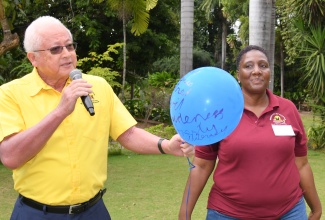 Director for the Victim Services Branch (VSB) in the Ministry of Justice, Dr. Nesta Haye, stands alongside Minister of Justice, Hon. Delroy Chuck, as he addresses students of the Oberlin High School ahead of a balloon release at Hope Gardens in St. Andrew on Thursday (February 6). The exercise was part of a resocialisation intervention held for children who have encountered traumatic experiences.