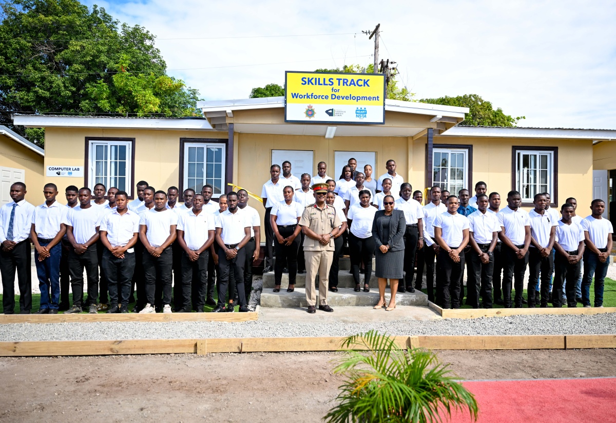 Force Executive Officer, Jamaica Defence Force (JDF), Brigadier Markland Lloyd, and Deputy Managing Director, National Training and Programmes Division, HEART/NSTA Trust, Dr. Cheryl McLaughlin, pose with the first 50 students who will participate in the Jamaica National Service Corps (JNSC) Skills Track for Workforce Development programme in front of a newly built computer lab where some of their lessons will be delivered. The programme was launched during a ceremony at JDF Headquarters, Up Park Camp, Kingston, on Monday (February 24).

