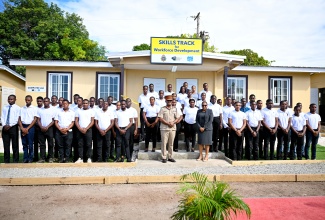 Force Executive Officer, Jamaica Defence Force (JDF), Brigadier Markland Lloyd, and Deputy Managing Director, National Training and Programmes Division, HEART/NSTA Trust, Dr. Cheryl McLaughlin, pose with the first 50 students who will participate in the Jamaica National Service Corps (JNSC) Skills Track for Workforce Development programme in front of a newly built computer lab where some of their lessons will be delivered. The programme was launched during a ceremony at JDF Headquarters, Up Park Camp, Kingston, on Monday (February 24).

