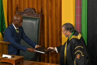Custos of Kingston, Hon. Steadman Fuller (left), is presented with the 2025/26 Throne Speech by President of the Senate, Senator the Hon. Thomas Tavares-Finson. Occasion was the ceremonial opening of Parliament at Gordon House on Thursday (February 13). Custos Fuller deputised for Governor General, His Excellency the Most Hon. Sir Patrick Allen.
