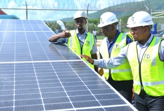Minister of Agriculture, Fisheries and Mining, Hon. Floyd Green ( right), and State Minister, Hon. Franklin Witter (centre), look at solar panels during the official handover of the Plumwood Pumping Station photovoltaics (PV) Solar System in New Forest, Manchester, in June 2023. Highlighting the features is Energy Engineer, National Irrigation Commission (NIC), Emile Mayers. The system was installed under the Rural Economic Development Initiative (REDI-II).