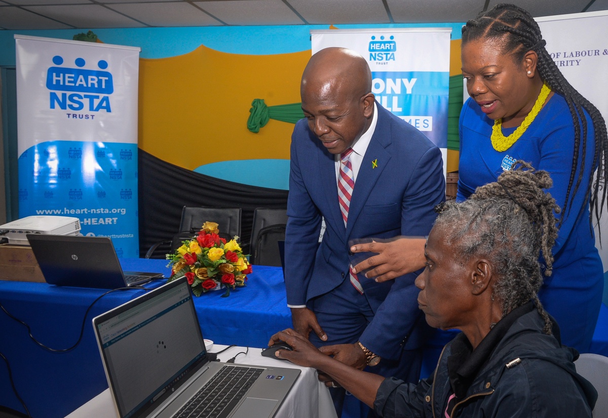 Minister of Labour and Social Security, Hon. Pearnel Charles Jr., and Regional Director, Region 1 HEART/NSTA Trust Dr. Sasha Shim-Hue (centre), interact with one of the participants in the GetConnected Digital Literacy Course during a visit at the National Council for Senior Citizens (NCSC) in Kingston on Thursday (February 6).  

