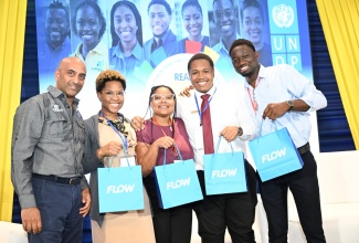 Resident Representative of the United Nations Development Programme (UNDP) Multi Country Office in Jamaica, Dr. Kishan Khoday (left), with the winners of the Development Challenge (from second left), Diandra Spence, Khygandhie Hall, Nicholas Lindo and Stafford Brown.

