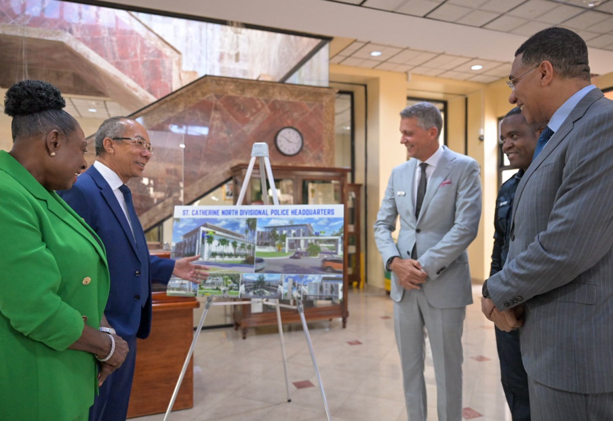 Prime Minister, Dr. the Most Hon. Andrew Holness (right), is in discussion with (from left) Minister of Culture, Gender, Entertainment and Sport and Member of Parliament for St. Catherine Central, Hon. Olivia Grange; Deputy Prime Minister and Minister of National Security, Hon. Dr. Horace Chang; Chairman, West Indies Home Contractors (WIHCON) Limited, Peter Melhado; and Commissioner of Police, Dr. Kevin Blake, during the contract-signing ceremony for the Jamaica Constabulary Force’s new St. Catherine North Divisional Headquarters, at the Office of the Prime Minister in St. Andrew in July last year.