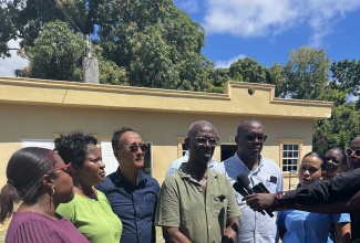 Minister of Local Government and Community Development, Hon. Desmond McKenzie (centre), speaks with journalists after visiting the Morant Bay Drop-In Centre in St. Thomas on Wednesday (February 26). With Mr. McKenzie are Councillors and staff of the St. Thomas Municipal Corporation and the Ministry, including Morant Bay Mayor, Councillor Louis Chin (third left).