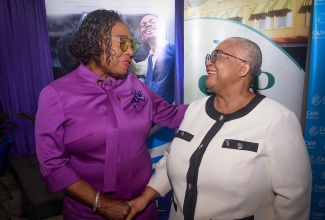 Culture, Gender, Entertainment and Sport Minister, Hon. Olivia Grange (left), greets Managing Director of the Jamaica Stock Exchange (JSE), Dr. Marlene Street Forrest, at the JSE’s ‘Ring the Bell for Gender Equality For All Women and Girls: Rights, Equality, Empowerment’ event, held on Monday (March 10) at the JSE offices in downtown Kingston.

