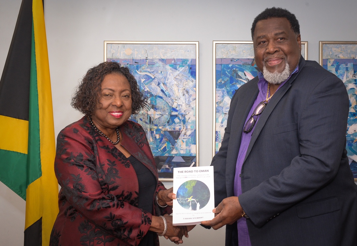 PHOTOS: Minister Grange Receives Copy of Book on Hockey Jamaica