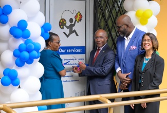 Minister of Industry, Investment and Commerce, Senator the Hon. Aubyn Hill (second left), and Programme Manager, Delegation of the European Union to Jamaica, Belize, The Bahamas, Turks and Caicos, and the Cayman Islands, Marlene Lamonth (left), officially open the newly established Jamaica Business Development Corporation (JBDC) Manchester Business Centre in Mandeville. Also participating in the proceedings are Permanent Secretary in the Ministry, Sancia Bennett Templer, and JBDC Acting Chief Executive Officer, Harold Davis.

