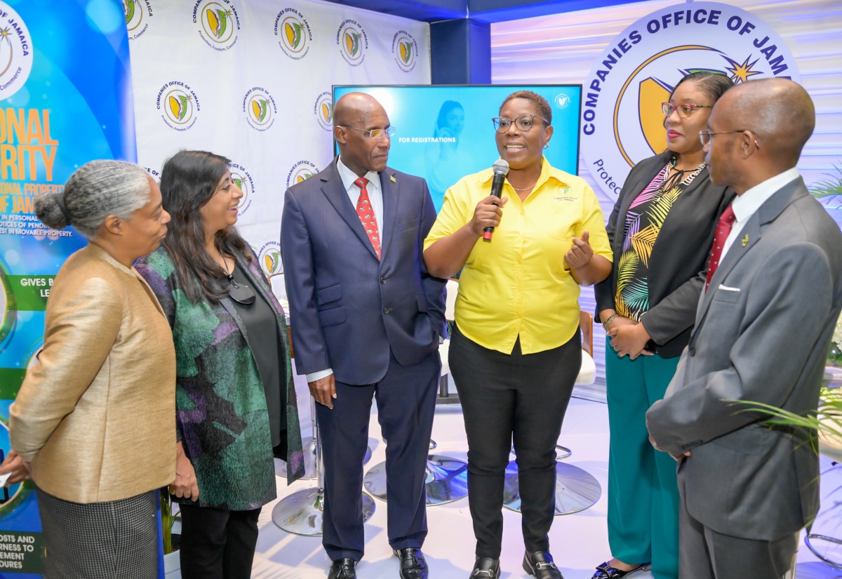 Minister of Industry, Investment and Commerce, Senator the Hon. Aubyn Hill (third left), along with (from left) Director of the Board, eGov Jamaica Limited, Shereen Jones; Chairman of eGov Jamaica, Professor Gunjan Mansingh; Chief Executive Officer, eGov Jamaica Limited, Anika Shuttleworth; and Permanent Secretary in the Office of the Prime Minister, Ambassador Rocky Meade, listens as Data Protection Officer, Companies Office of Jamaica, Yolande Rowe-Fender (third right) explains the services of the organisation. The occasion was the third staging of the eGov Jamaica Limited Digital Government Technology Showcase on Thursday (March 13) at The Jamaica Pegasus hotel in Kingston. It was held under the theme, ‘Digital Transformation Unlocked: Shaping Jamaica’s Tomorrow’.