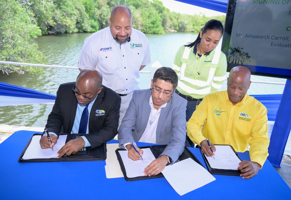 Chief Executive Officer, National Environment and Planning Agency (NEPA), Leonard Francis (seated left); Managing Director, Caribbean Cement Company Limited (CCCL), Jorge Martínez (seated centre) and Director responsible for Environmental Management and Conservation, NEPA, Anthony McKenzie (seated right), affix their signatures to documents formalising the partnership between NEPA & CCCL for CCCL’s participation in the Adopt-A-Mangrove programme at the Caribbean Cement Company Limited Sports Club, Rockfort, Kingston, on Tuesday, March 18. Witnessing the signing (from left) are Legal Counsel, CCCL, Craig Neil and Sustainability Leader, CCCL, Shannen Suckra Baker.

