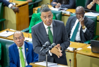 Prime Minister, Dr. the Most Hon. Andrew Holness, makes his contribution to the 2025/2026 Budget Debate in the House of Representatives on Thursday (March 20). Seated at left is Deputy Prime Minister and Minister of National Security, Hon. Dr. Horace Chang.