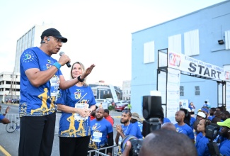 Prime Minister, Dr. the Most Hon. Andrew Holness (left), addresses participants at the start of the European Union (EU)-Jamaica 50th anniversary 5K and 10K Run in downtown Kingston on Sunday (March 9). Looking on is Ambassador of the European Union (EU) to Jamaica, Her Excellency Dr. Erja Askola (right). This year