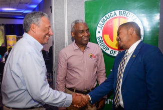 Minister of Agriculture, Fisheries and Mining, Hon. Floyd Green (right) greets Jamaica Broilers Group Chief Executive Officer (CEO) and President, Christopher Levy (left) ahead of the Agri-Vision Forum held at The Jamaica Pegasus hotel in Kingston on Tuesday (March 4). Also present is Vice President of The Best Dressed Chicken, Dave Fairman.

