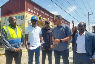 Prime Minister, Dr. the Most Hon. Andrew Holness (second right), gets an update on the Grange Lane Dualisation Project in Portmore, St. Catherine, from Senior Director of Project Implementation at the National Works Agency (NWA), Varden Downer (second left), during a tour of the area on Friday (February 28). Looking on are (from left) National Water Commission (NWC) Regional Manager for Clarendon and St Catherine, Garwaine Johnson; Minister without Portfolio in the Ministry of Economic Growth and Job Creation with responsibility for Works, Hon. Robert Morgan, and Member of Parliament for St. Catherine East Central and Minister of State in the Ministry of Foreign Affairs and Foreign Trade, Hon. Alando Terrelonge.