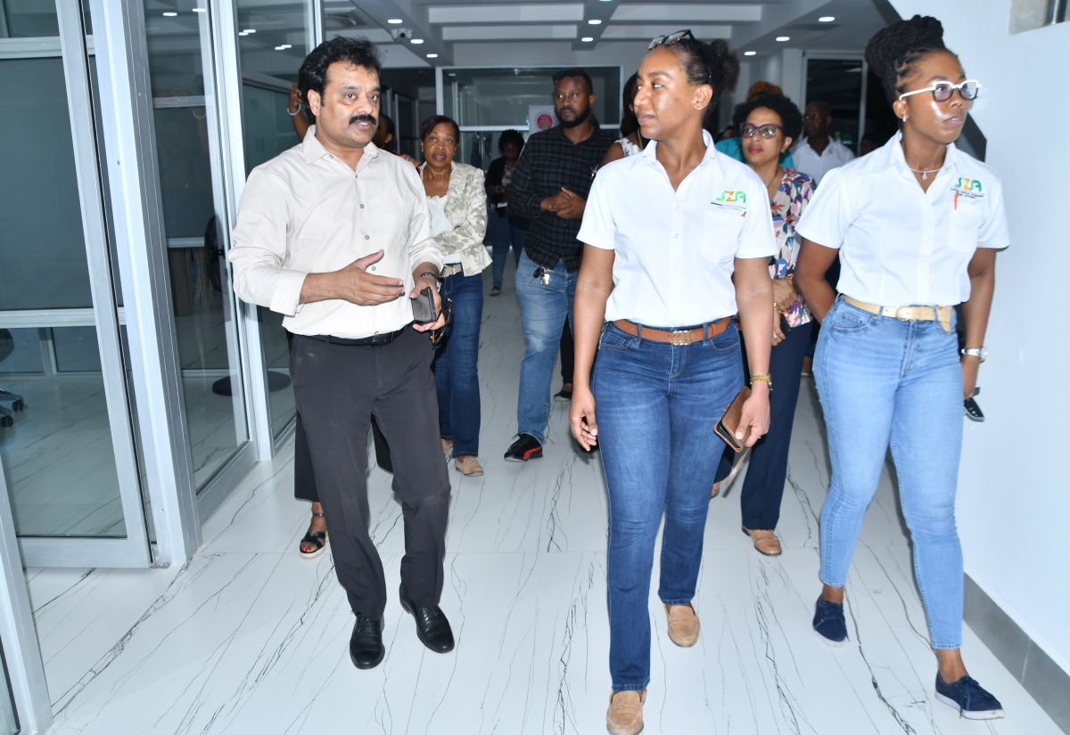 Jamaica Special Economic Zone Authority (JSEZA) Senior Director of Business Partner and Support Services, Licia Grant (centre), and Director of Stakeholder Relationship Management, Yeuniek Hinds (right), along with other stakeholders are led on a recent tour of the Bioprist Institute of Medical Sciences (BIMS) building in Montego Bay, St. James, by Founder and President of the Bioprist Group and Indies Group, Dr. Guna Muppuri (left). BIMS was one of several special economic zones (SEZ) business locations visited by representatives of JSEZA.

