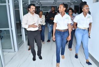 Jamaica Special Economic Zone Authority (JSEZA) Senior Director of Business Partner and Support Services, Licia Grant (centre), and Director of Stakeholder Relationship Management, Yeuniek Hinds (right), along with other stakeholders are led on a recent tour of the Bioprist Institute of Medical Sciences (BIMS) building in Montego Bay, St. James, by Founder and President of the Bioprist Group and Indies Group, Dr. Guna Muppuri (left). BIMS was one of several special economic zones (SEZ) business locations visited by representatives of JSEZA.

