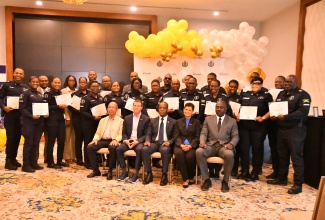 Minister of National Security, Hon. Dr. Horace Chang (seated, left) along with (seated from second left) Executive Chairman of Sandals Resorts International (SRI) Adam Stewart; Commissioner of Police, Dr. Kevin Blake; Senior Corporate Director of the Sandals Corporation University (SCU), Dr. Luz Longsworth; and Deputy Commissioner of Police, Warren Clarke, share a moment with the high-ranking officers of the Jamaica Constabulary Force (JCF) Area One police division who were awarded certificates after participating in SCU’s Leadership Training Initiative. Occasion was the certificate presentation ceremony for the programme which was held on Thursday (March 13) at Sandals Montego Bay in St. James.