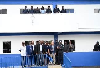 Deputy Prime Minister and Minister of National Security, Hon. Dr. Horace Chang (second right), cuts the ribbon to officially open the Frome Police Station in Westmoreland on March 14. Looking on are Permanent Secretary, Ambassador Alison Stone Roofe (second left), Commissioner of Police, Dr. Kevin Blake (right) and other stakeholders.
