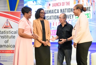 Minister of National Security, Hon. Dr. Horace Chang (second right), engages in conversation with (from left) Permanent Secretary in the Ministry, Ambassador Alison Stone Roofe; Director of the Surveys Division, Statistical Institute of Jamaica (STATIN), Dr. Natalee Simpson; and Acting Director General, STATIN, Leesha Delatie-Budair at the launch of the 2023 Jamaica National Crime Victimisation Survey (JNCVS). The JNCVS launch was held at the AC Marriott Hotel in Kingston today (March 28).